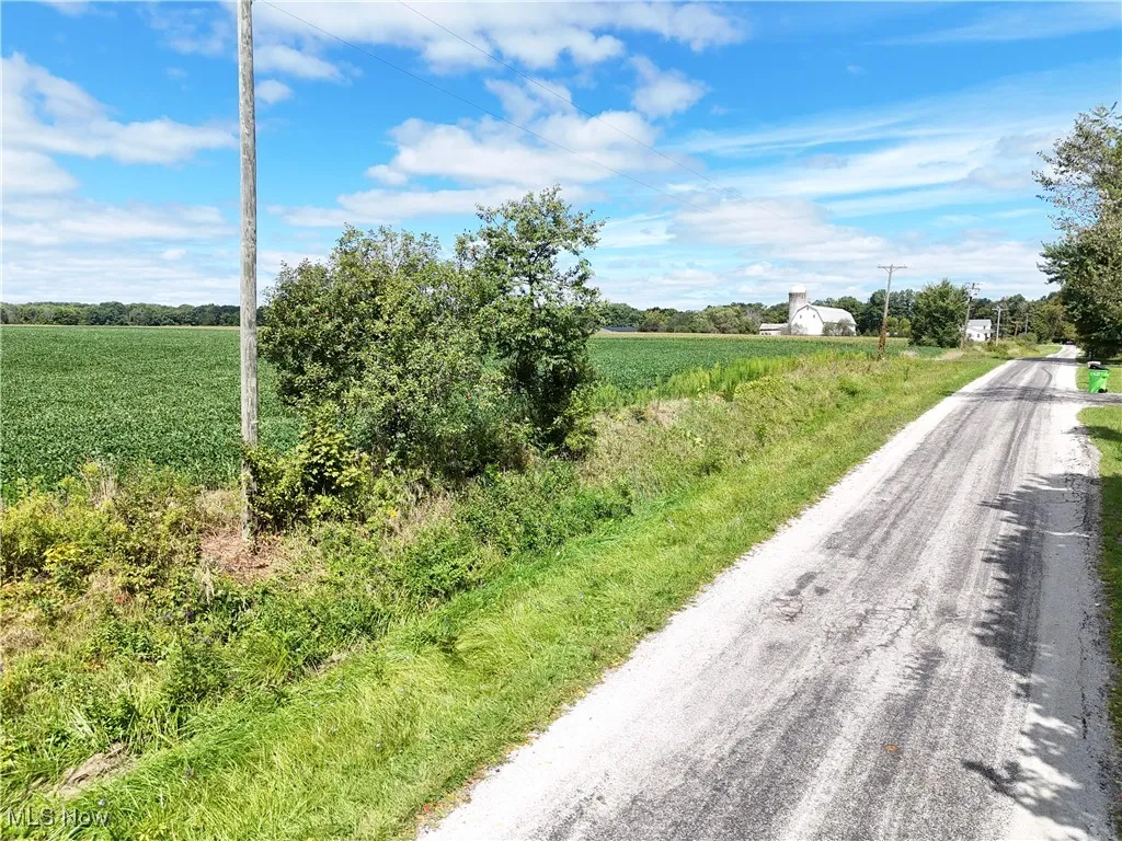 View of asphalt road with a rural view