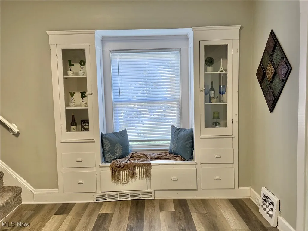 Serve and Enjoy your meals in the Gorgeous Dining room with Original Built ins ~  Fresh Paint, Luxury Vinyl Flooring and Lighting ~  Replacement windows with Blinds ~