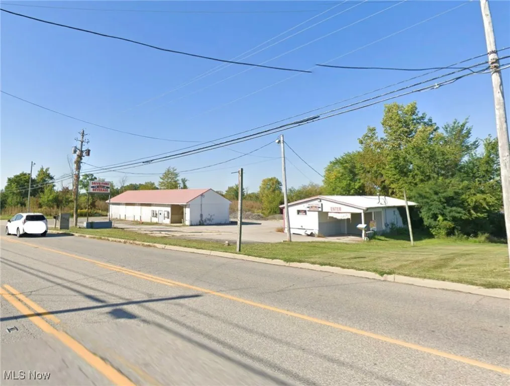 View of asphalt road featuring curbs