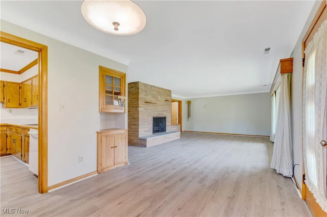 Family Room with LVT flooring and a brick woodburning fireplace.