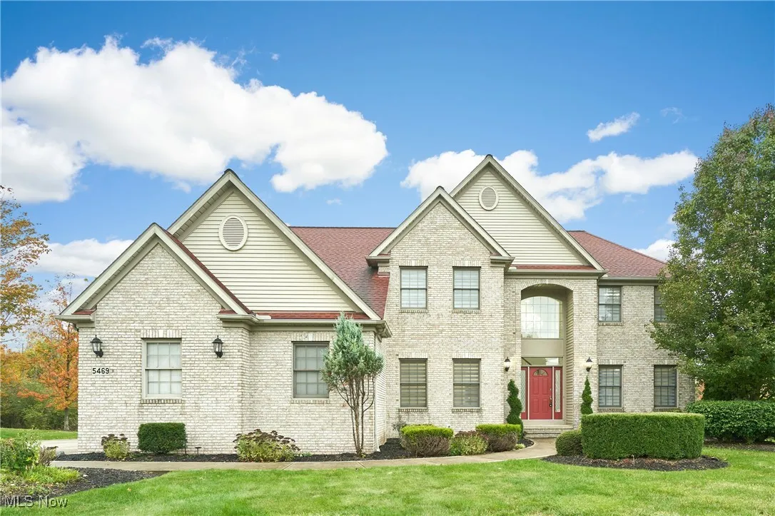 View of front facade with brick siding and a front yard