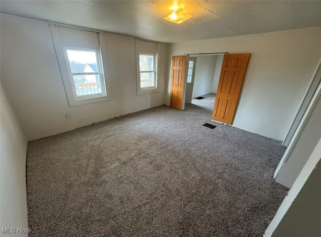 Unfurnished bedroom with carpet floors