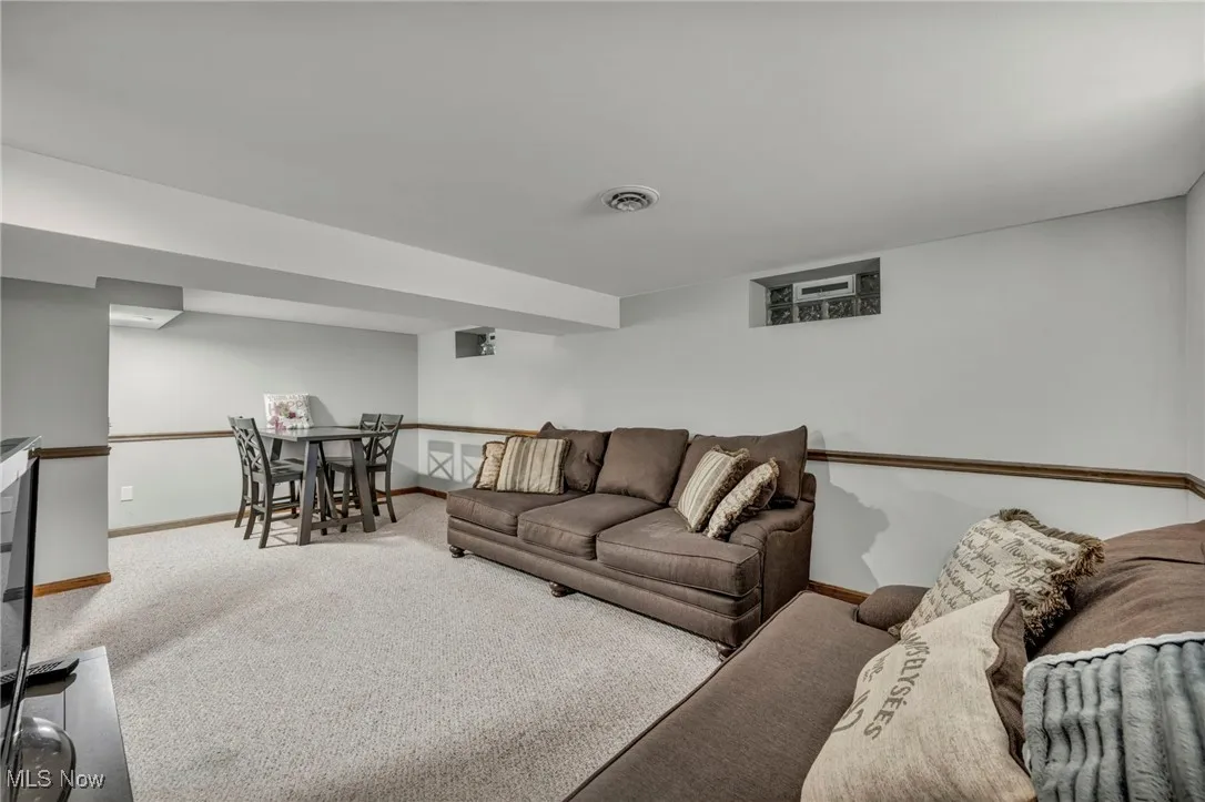 Carpeted living room featuring baseboards