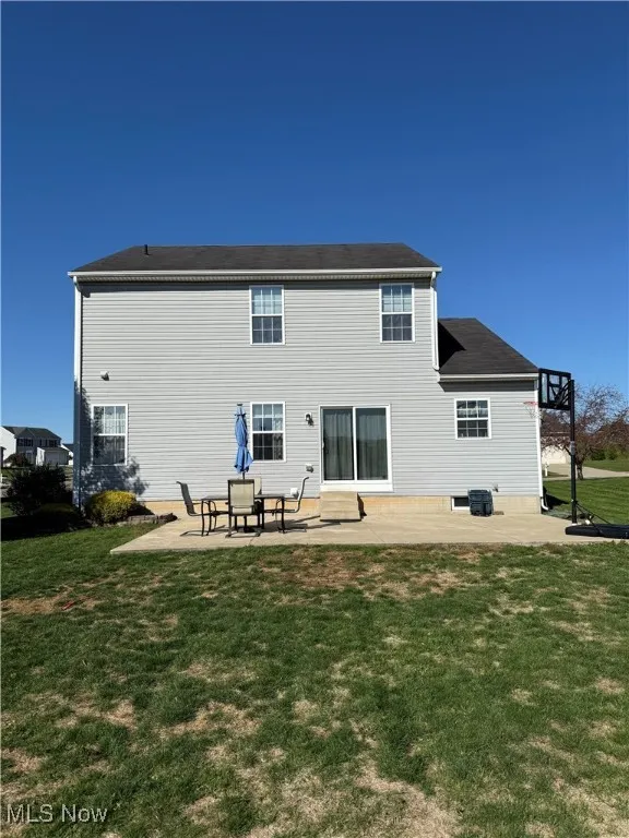Back of house featuring a patio and a lawn