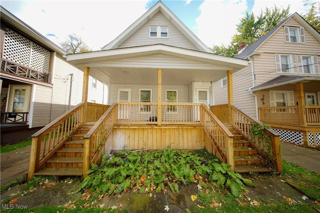 View of front of house featuring stairway and covered porch