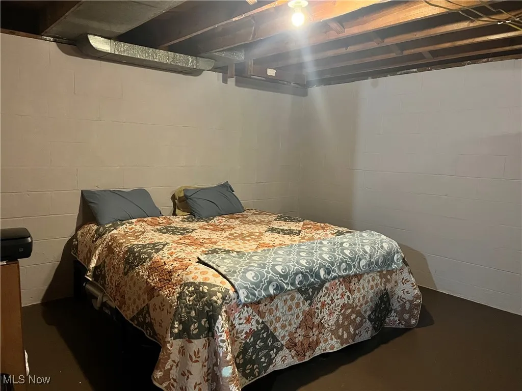 Bedroom featuring finished concrete flooring