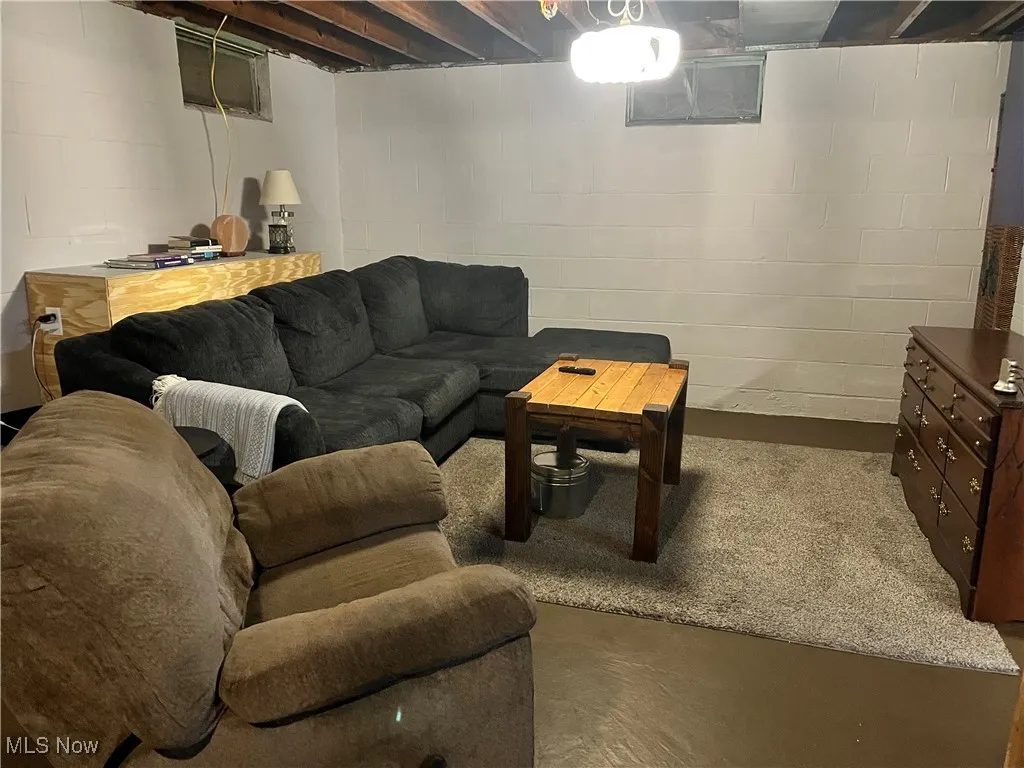 Living room featuring concrete flooring
