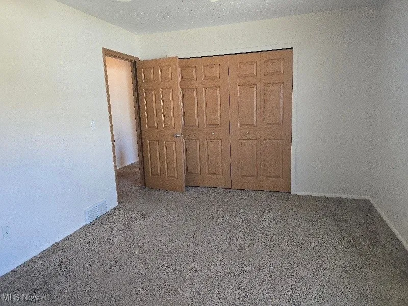 Unfurnished bedroom featuring a closet
