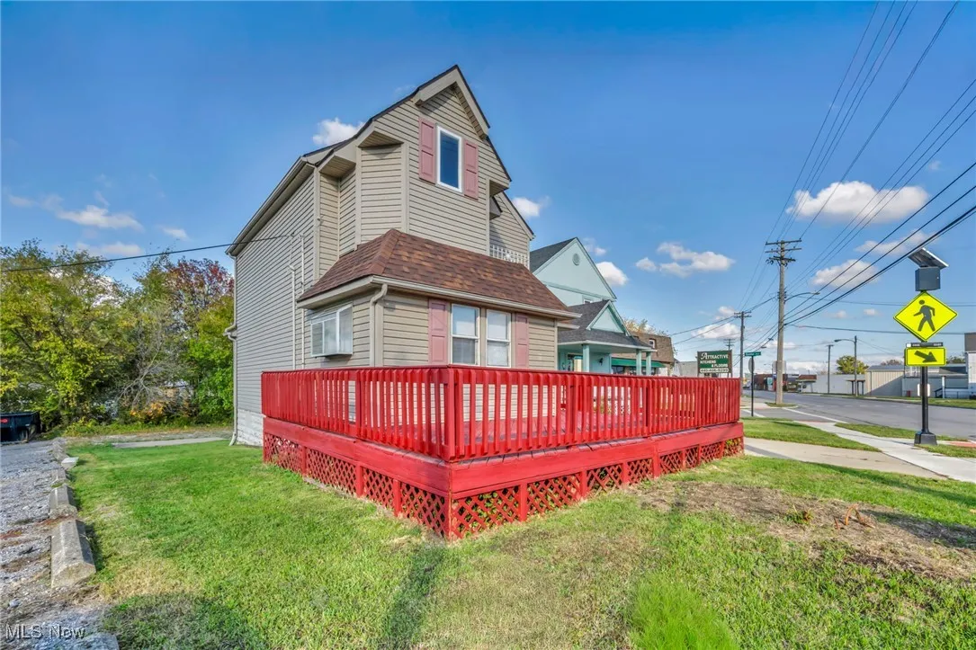 View of home's exterior featuring a yard and a wooden deck