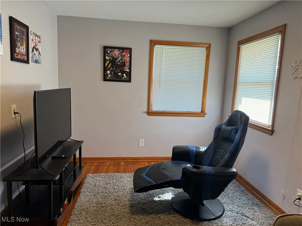 Living area featuring baseboards and wood finished floors