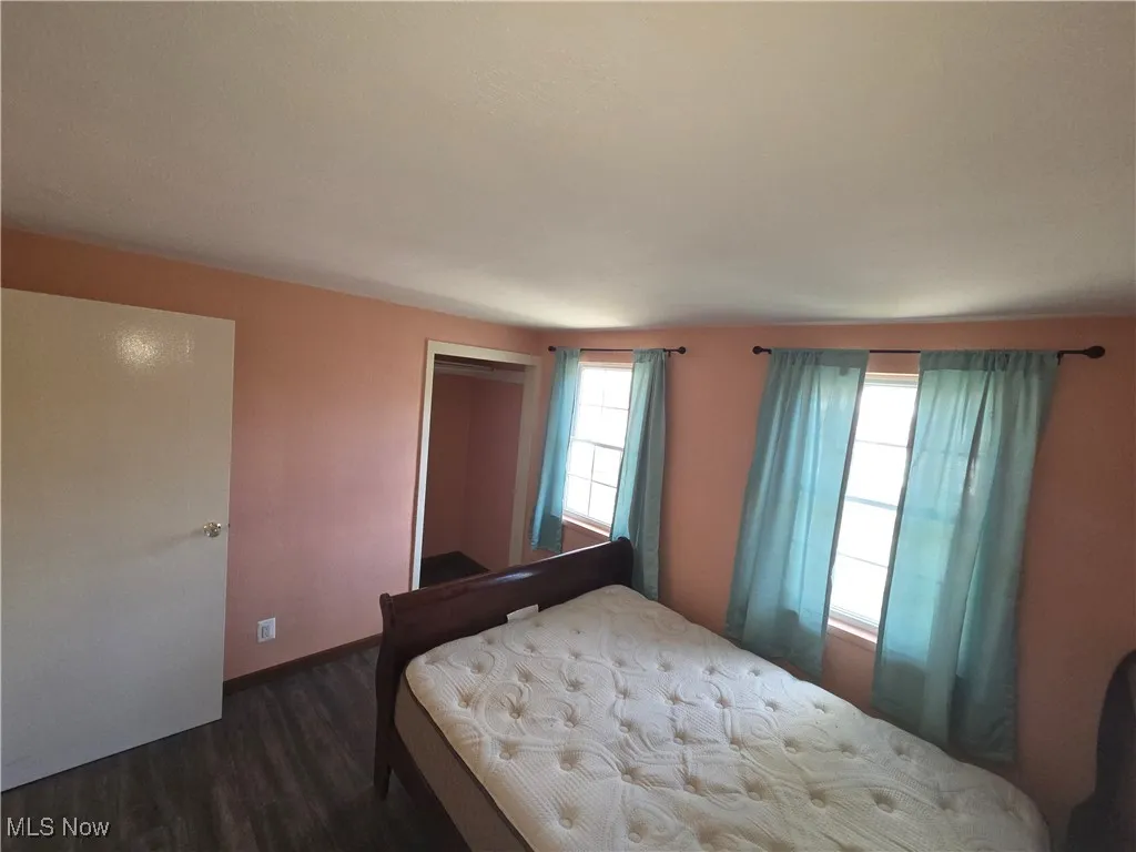 Bedroom with a closet and dark wood finished floors