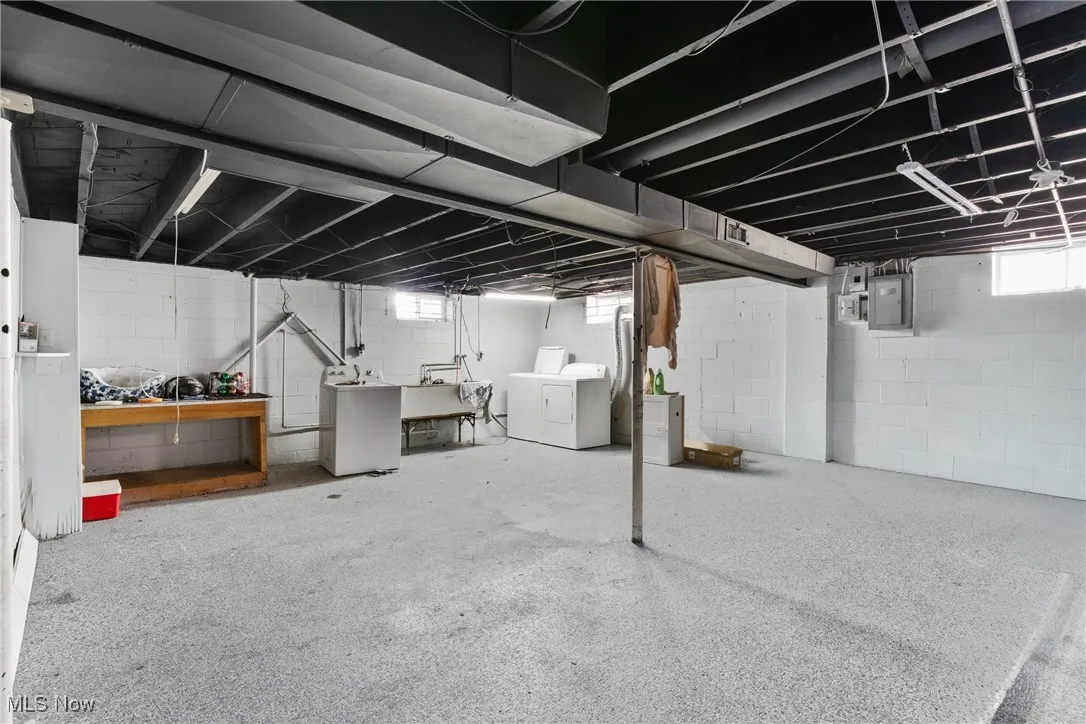 Basement featuring washer and clothes dryer and electric panel