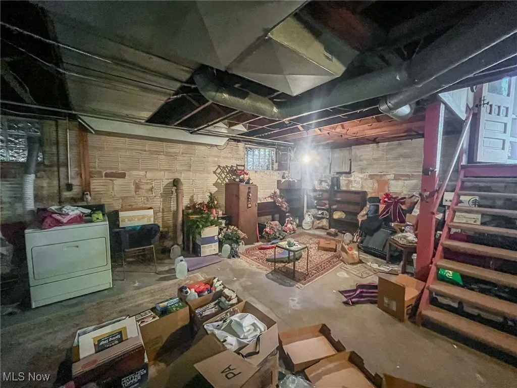 Below grade area with washer / dryer and stairway