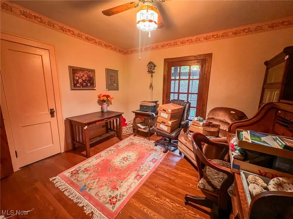 Living area with wood finished floors and ceiling fan