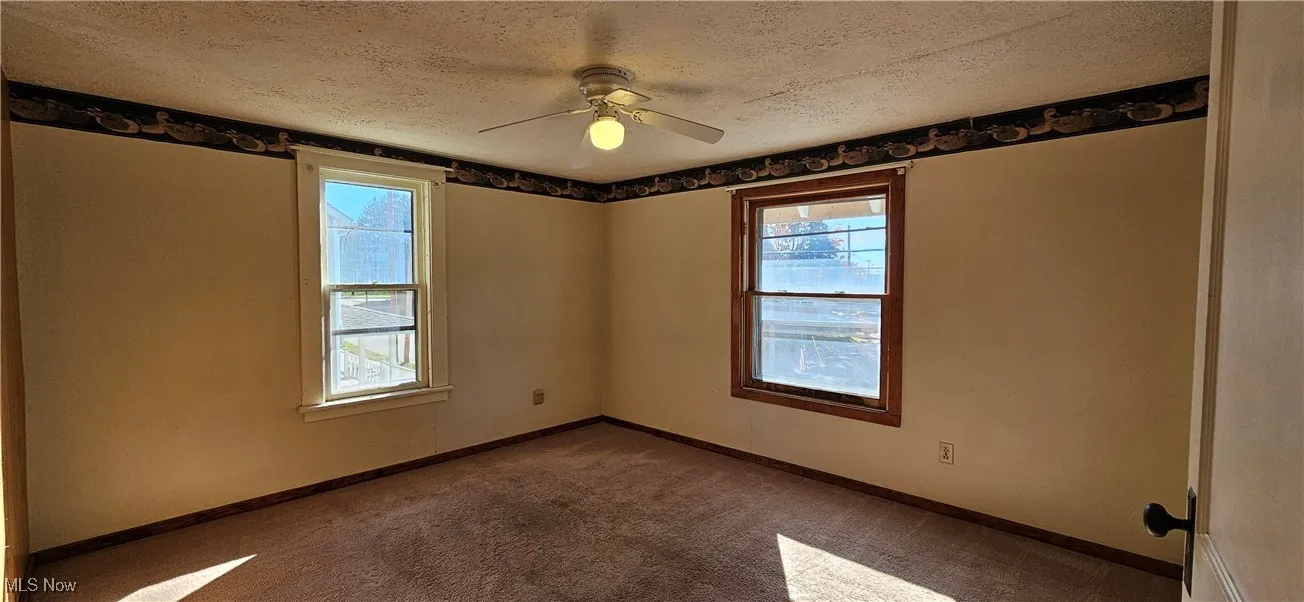 Bedroom with carpet and a ceiling fan