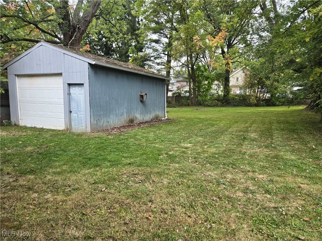 View of back yard with a detached garage