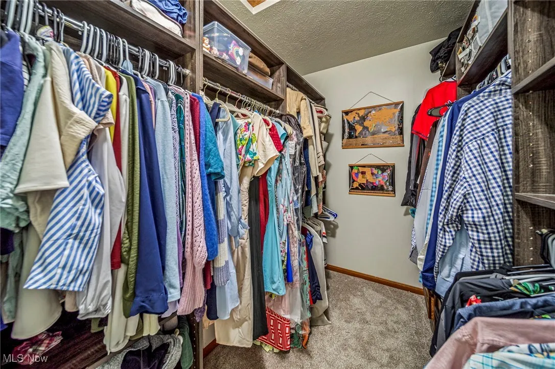 Primary bedroom closet with custom shelving.
