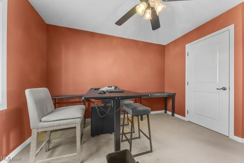 Bedroom with light carpet and a desk