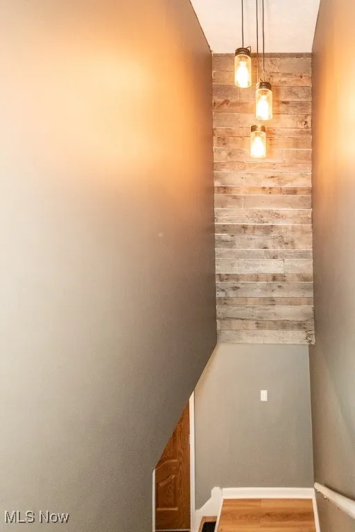 Stairs with wood walls and wood finished floors