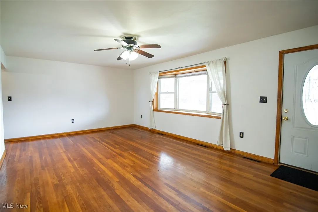 Foyer with wood-type flooring and a ceiling fan