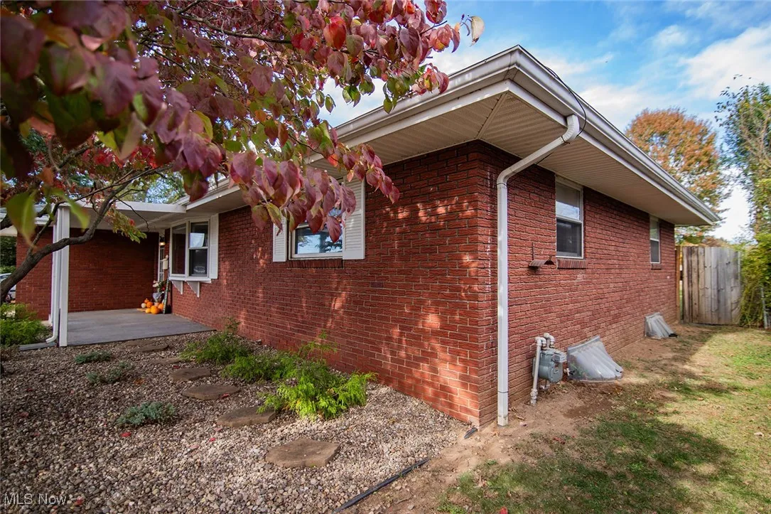 View of property exterior featuring brick siding