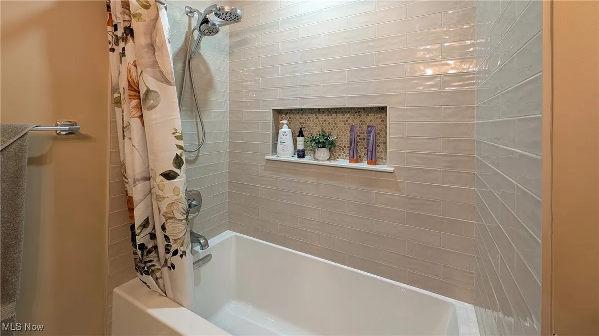 Beautifully remodeled hall bath with soaker tub and custom ceramic tile surround