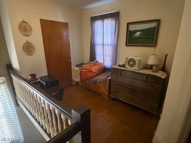 Bedroom featuring dark wood-style flooring