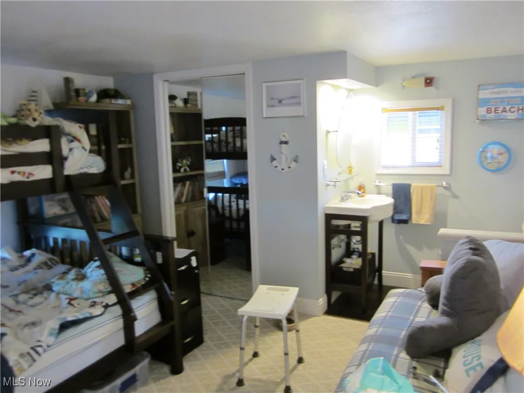 Living room featuring baseboards and light carpet
