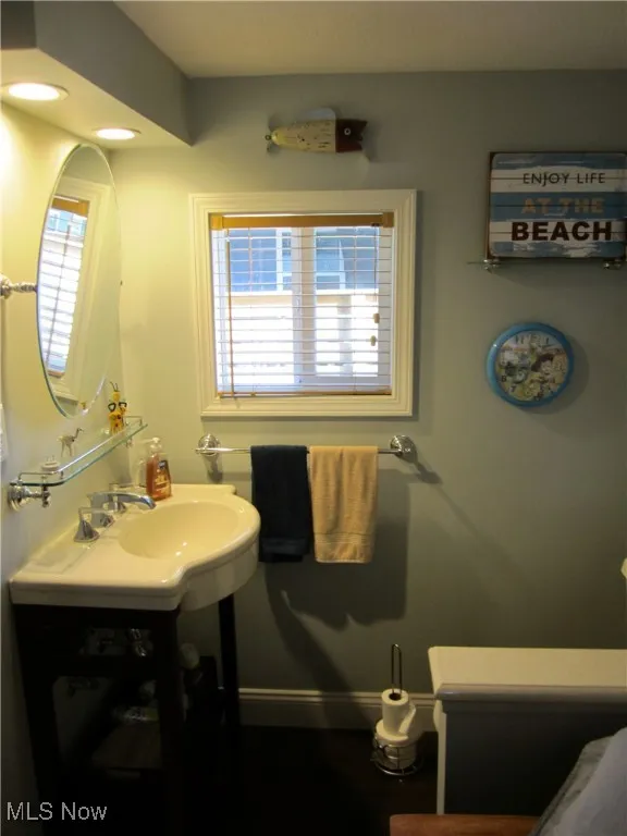 Bathroom with vanity and baseboards