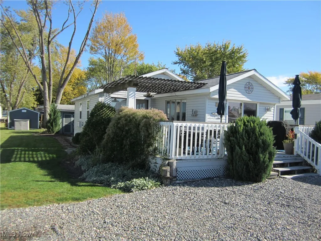 View of front of home with a front yard and a deck