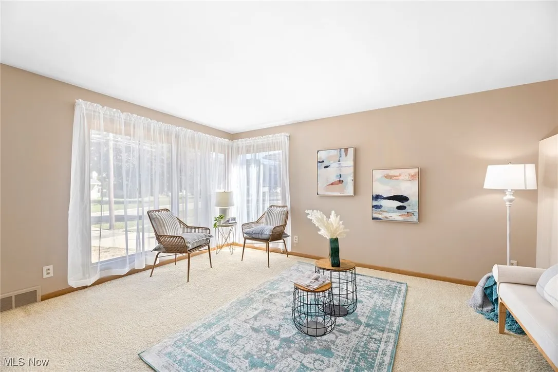 Sitting room with carpet and baseboards