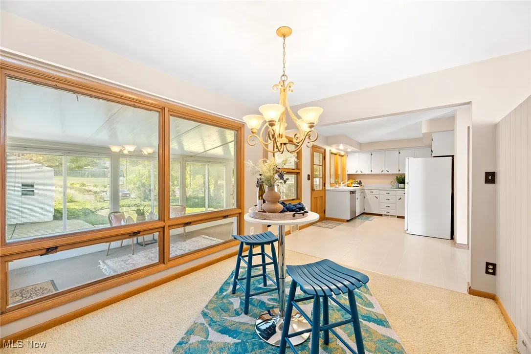 Dining space featuring a chandelier and light carpet