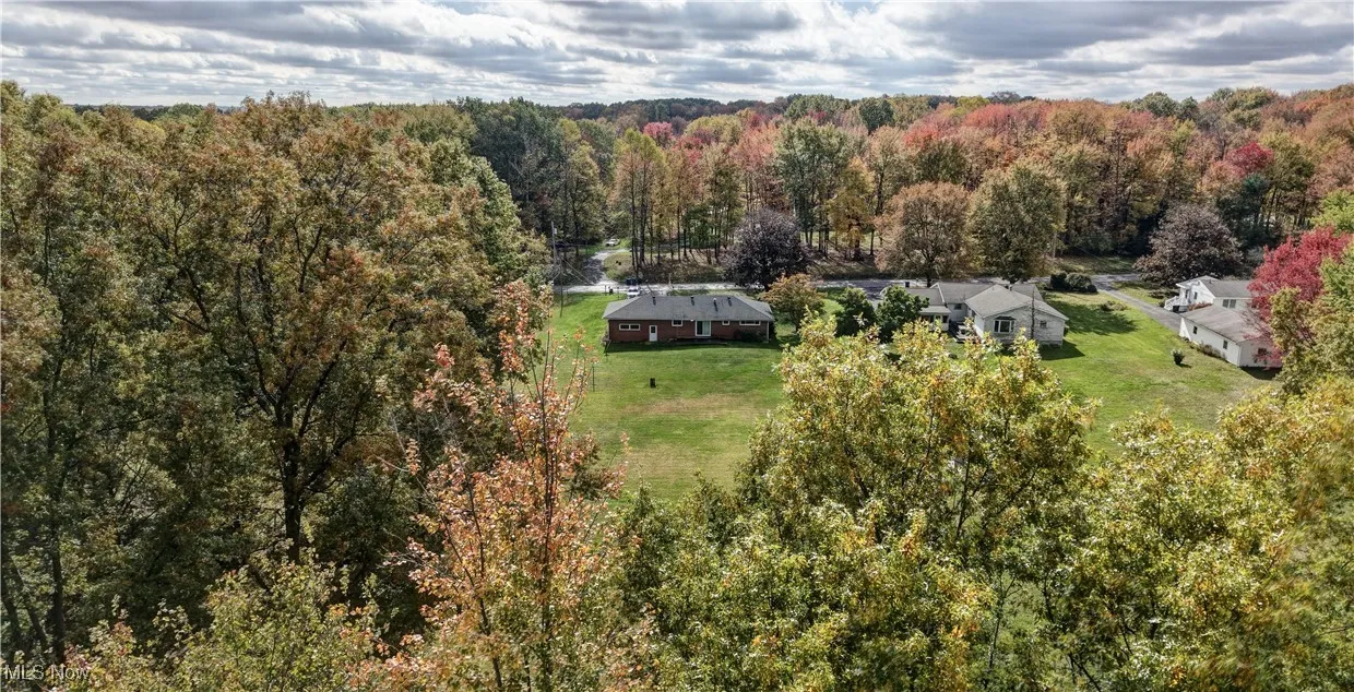 View of subject property featuring a heavily wooded area