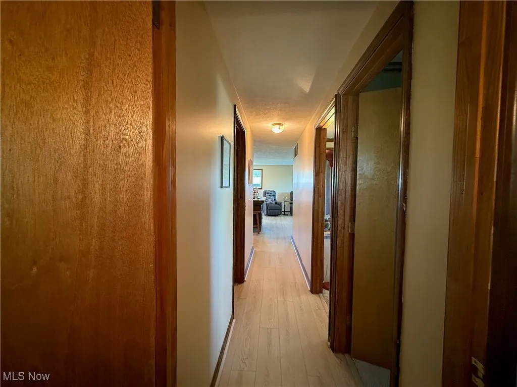 Hallway featuring light wood-style flooring