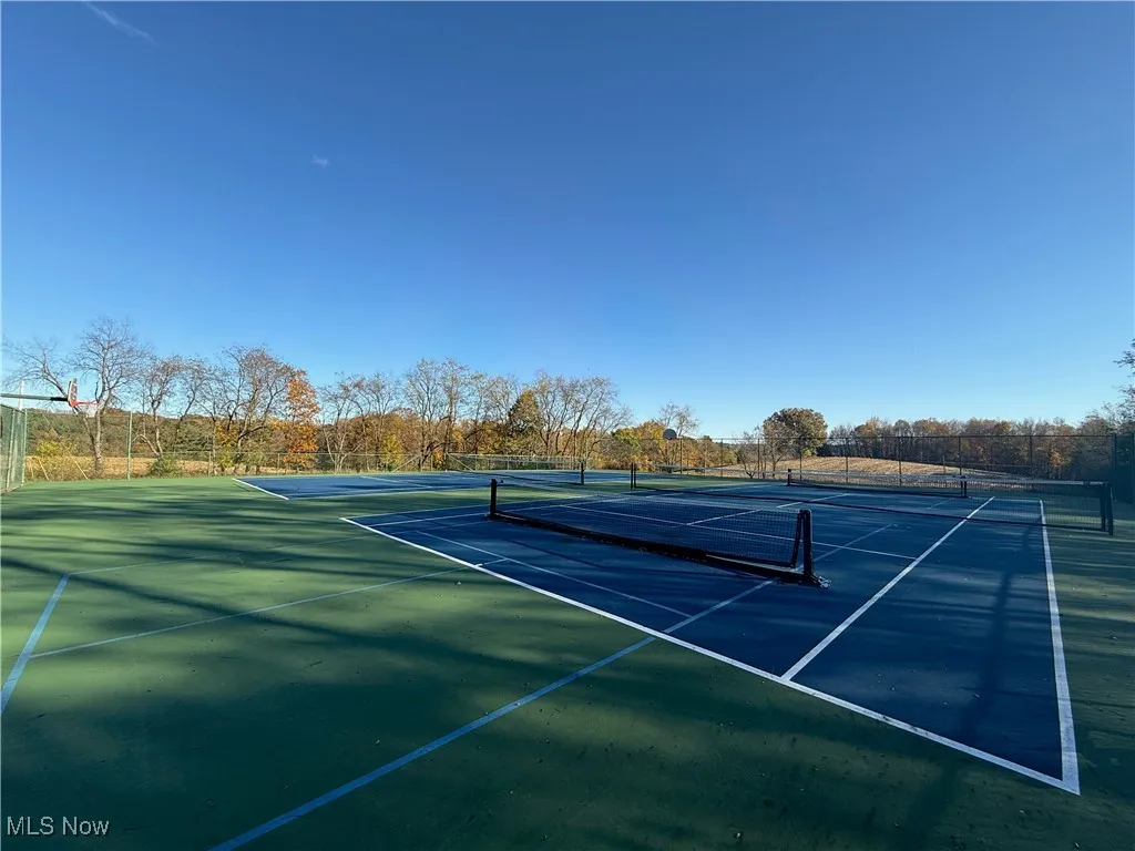 View of tennis court featuring community basketball court