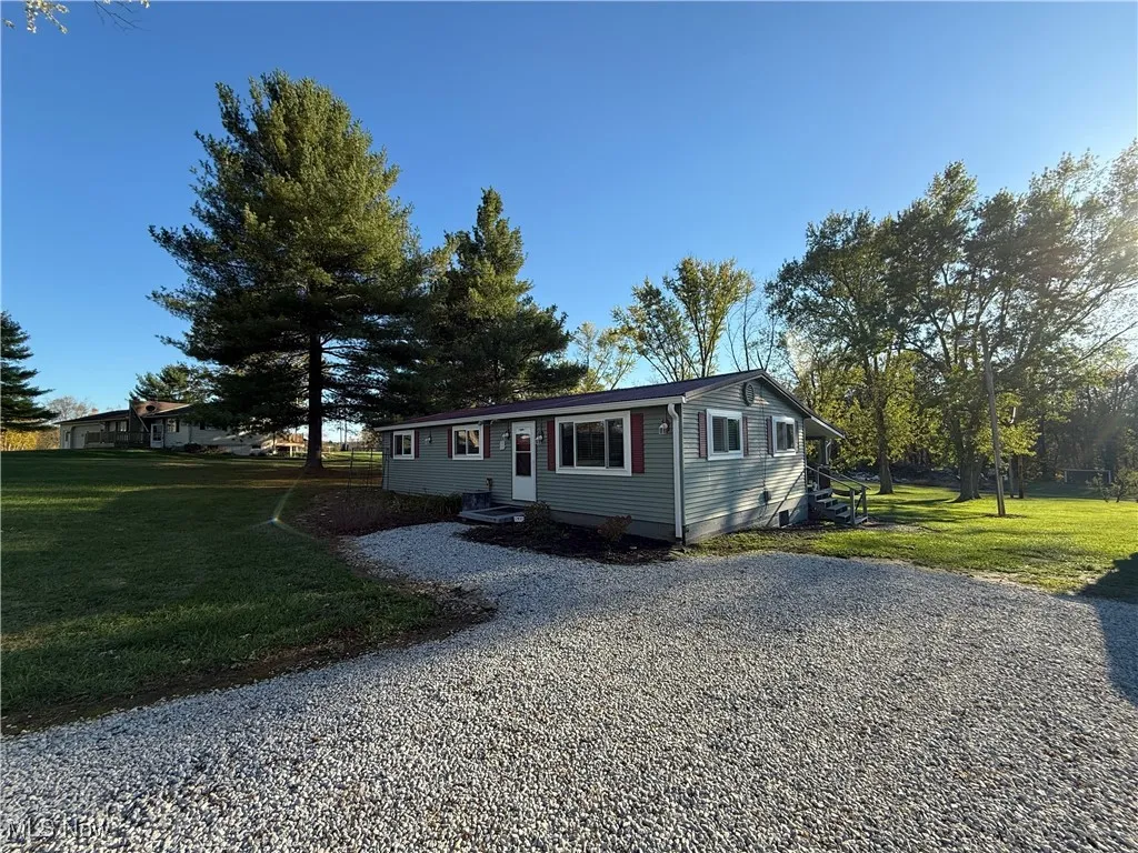 View of front of home with a front yard and entry steps
