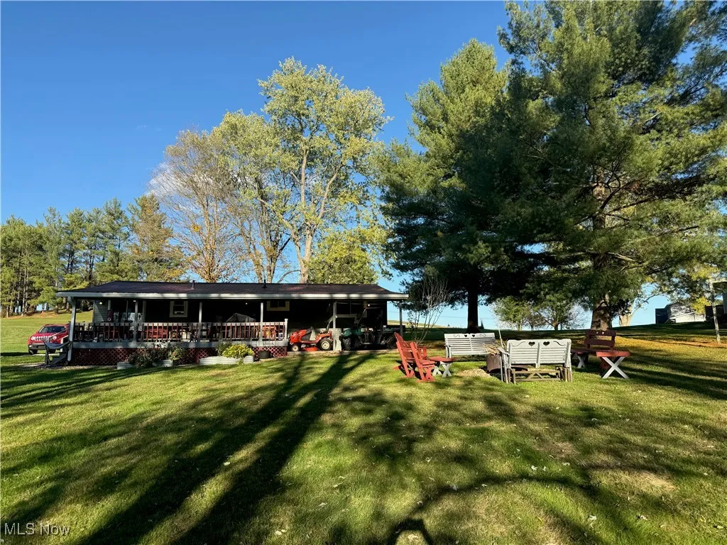 Back of house with a lawn