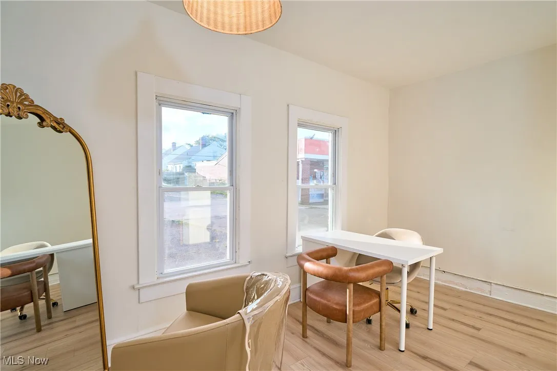 Sitting room featuring light wood finished floors and an office area