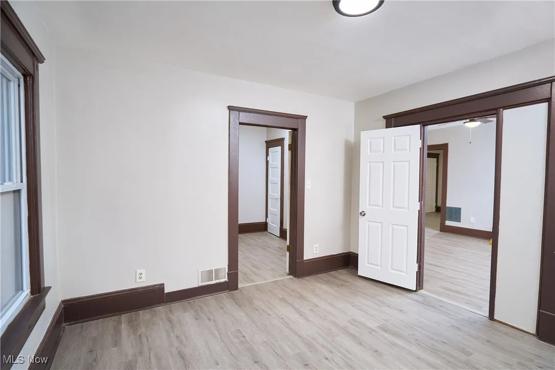 Empty room with light wood finished floors and baseboards