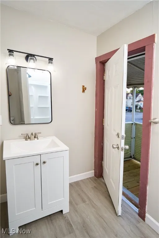Bathroom featuring light wood-type flooring and vanity