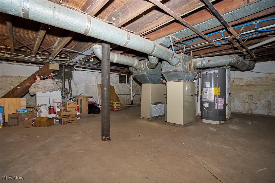 Unfinished basement with gas water heater and heating unit