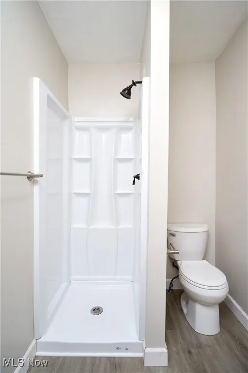 Bathroom featuring a stall shower and light wood-style flooring