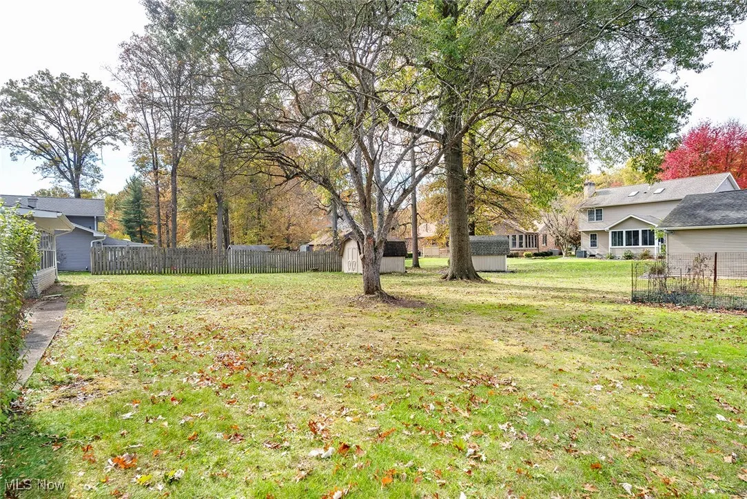 Fenced backyard with a storage unit