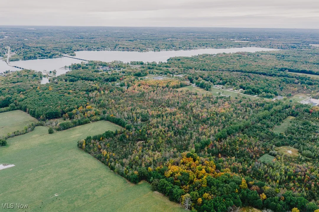 Aerial view of a heavily wooded area and a large body of water