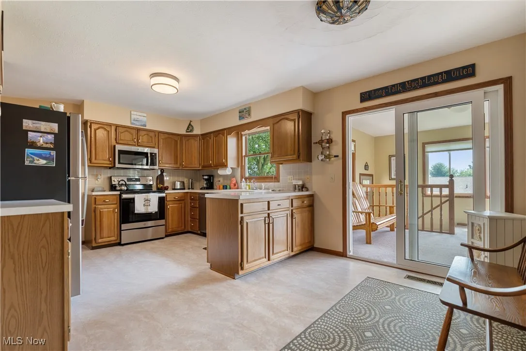 The dining space in the kitchen sits next to the slider to the sun room.