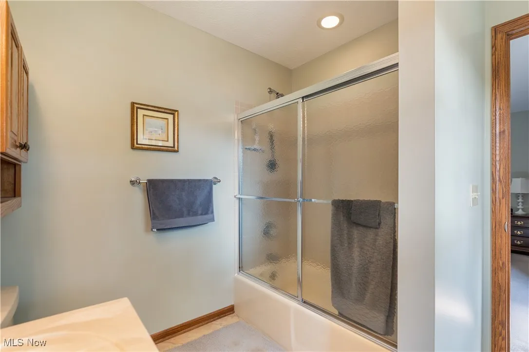 Full bathroom featuring enclosed tub / shower combo.