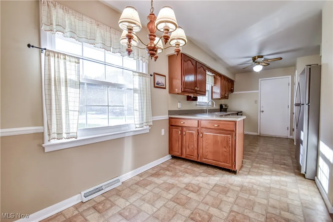 Kitchen with healthy amount of natural light, hanging light fixtures, and a chandelier