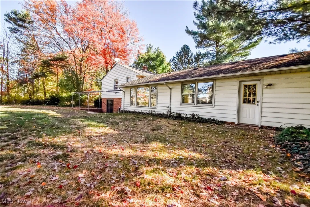 Back of property featuring a yard