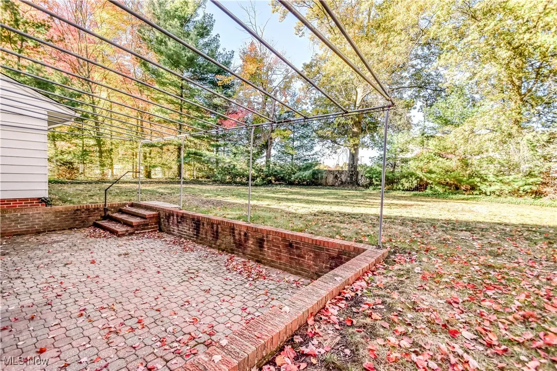 View of grassy yard with a patio