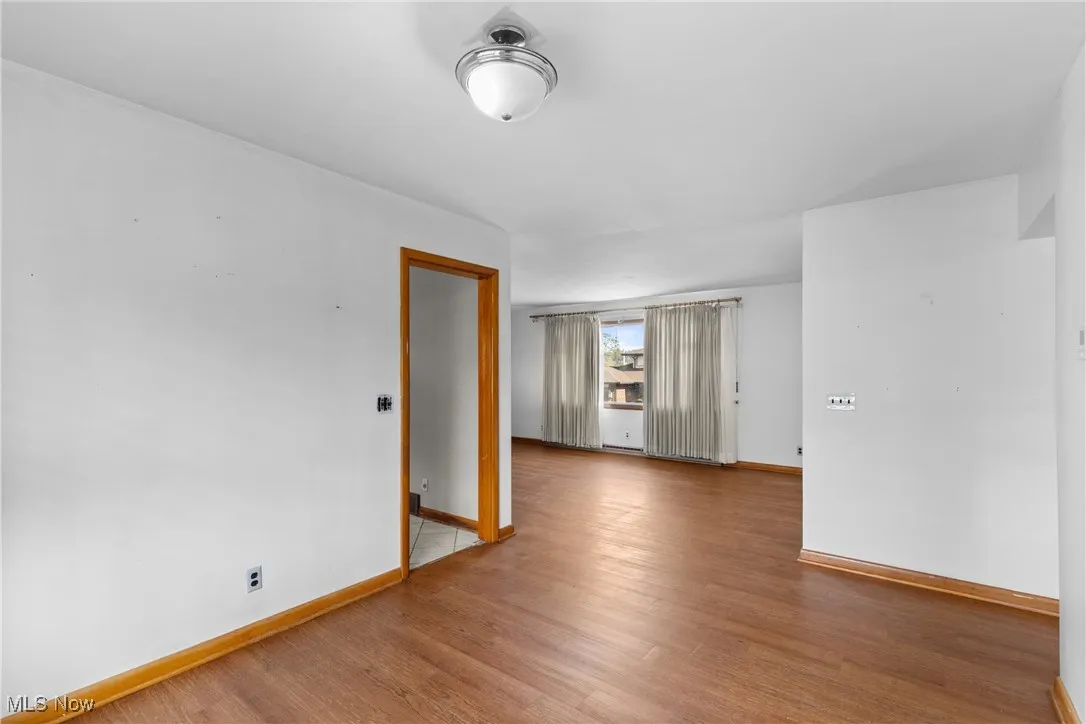 Empty room with wood finished floors and baseboards